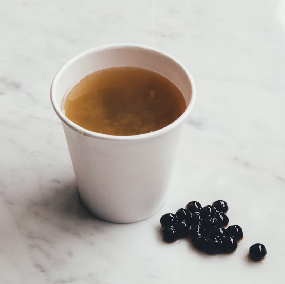 A close view of Cha1004 bubble tea with tapioca pearls